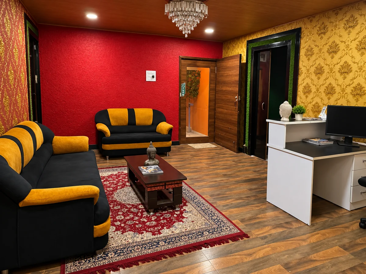 Aroma reception with black and mustard seating, red walls and wooden flooring